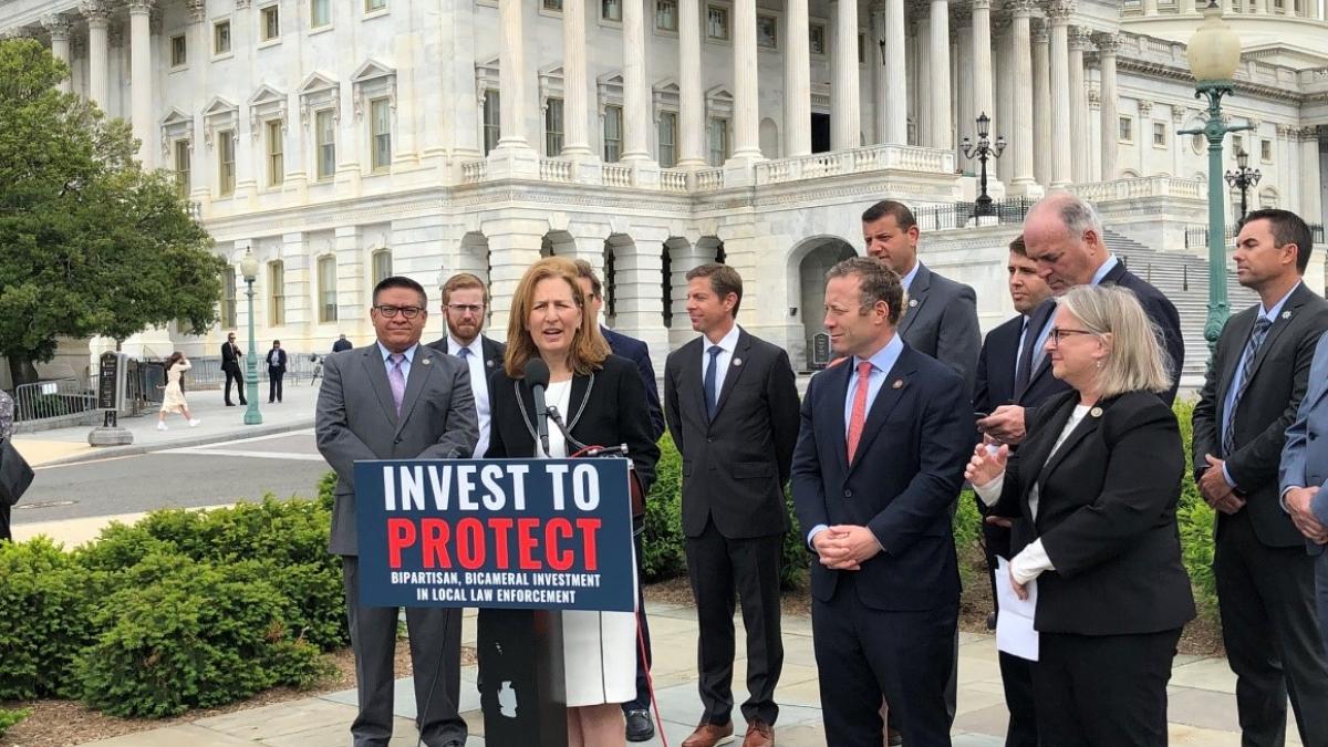 Rep. Schrier in front of U.S. Capitol for Invest to Protect Act press conference
