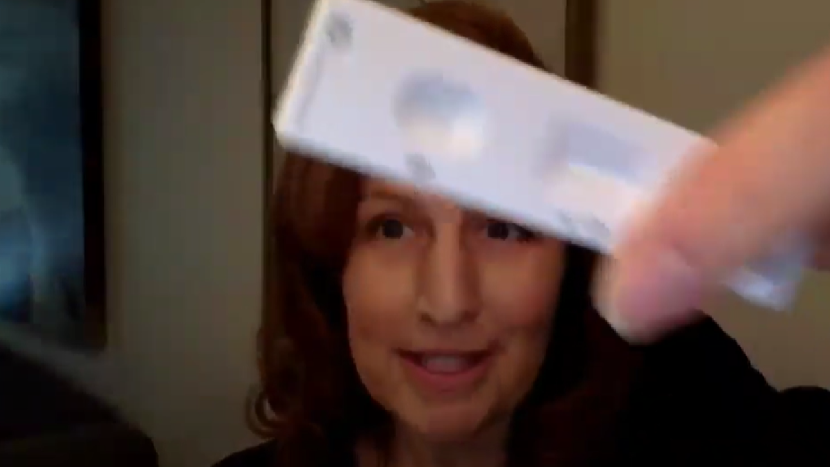 Schrier holding rapid test