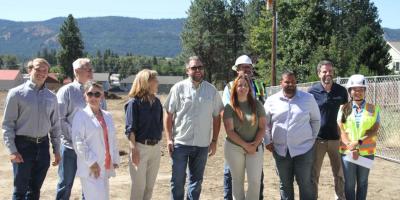 HopeSource and local officials and Congresswoman Kim Schrier gather for a group picture at a previous team meeting to go over Teanaway Court plans on July 29.