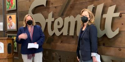 Rep. Schrier with apple Under Secretary of USDA