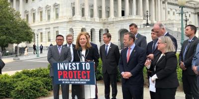 Rep. Schrier in front of U.S. Capitol for Invest to Protect Act press conference