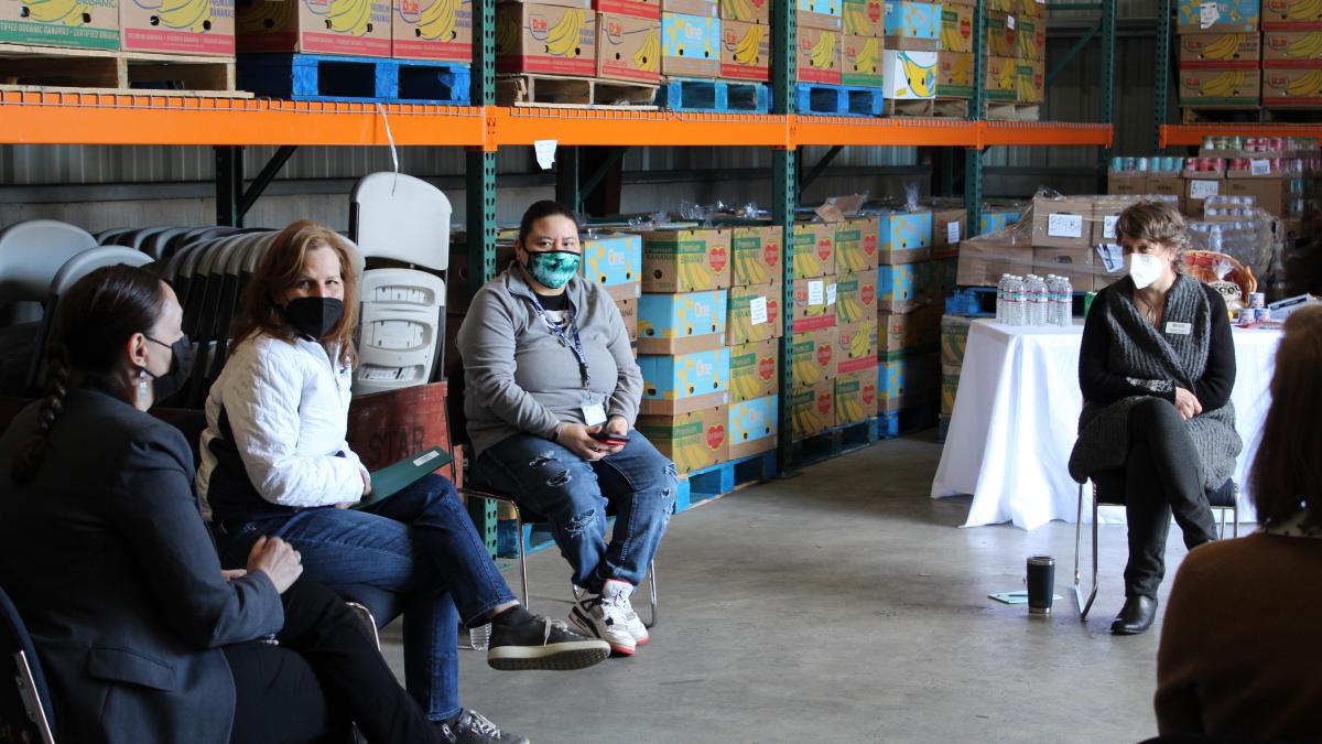 U.S. Rep. Schrier speaking with reps from local food banks